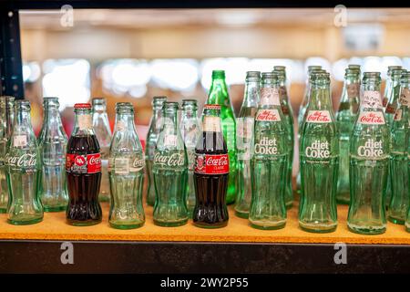 Old vintage Coca-Cola or Coke bottles on display in a shelf, for sale in an antique store in Montgomery Alabama, USA. Stock Photo