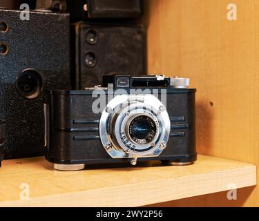 Old vintage antique Argus camera, an old film camera, on a shelf for sale in an antique store in Montgomery Alabama, USA. Stock Photo