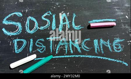 "Social Distancing" text on a black and crayon background Stock Photo