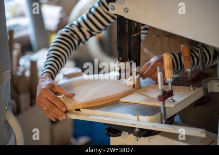Carpentry workshop, craftsman master working. Joiner hands carved on wood with special equipment Stock Photo