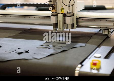 Automatic flatbed digital cutting system close up. CNC leather cutting machine. Selective focus. Stock Photo
