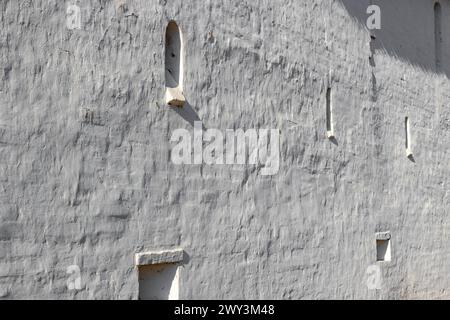 Background in the form of an old white wall of an ancient monastery Stock Photo
