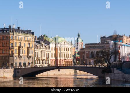 Central Stockholm, Sweden. Royal Opera house, St Jacob's church and Gustav II Adolf square. Bridge towards the old town. Historical buildings. Sun. Stock Photo