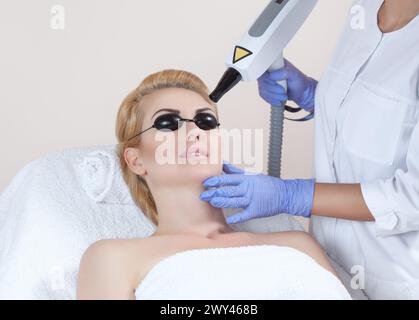 Laser tattoo removal on woman's eyebrows in a beauty salon Stock Photo