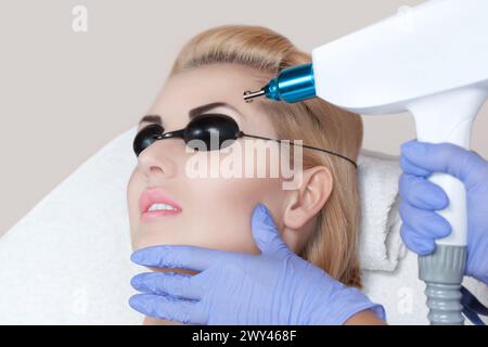 Laser tattoo removal on woman's eyebrows in a beauty salon Stock Photo