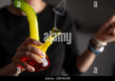 Woman Smokes Marijuana With Bong In Close-Up, Representing Lifestyle ...