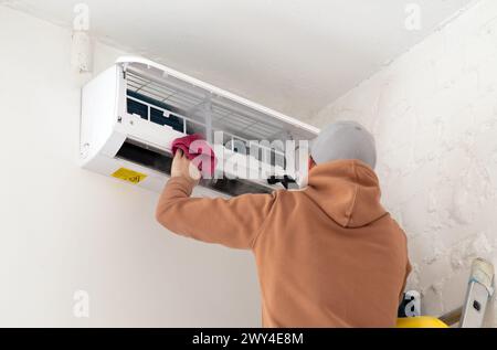 Technician service using vacuum cleaner to cleaning the air conditioner. High quality photo Stock Photo