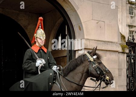 A mounted trooper of the Blues and Royals cavalry regiment on duty at Horse Guards, the formal entrance to St. James’s Palace and Buckingham Palace, Stock Photo