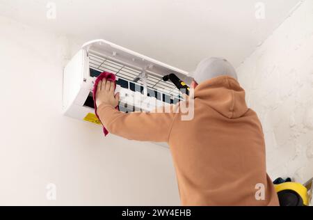 Technician service using vacuum cleaner to cleaning the air conditioner. High quality photo Stock Photo
