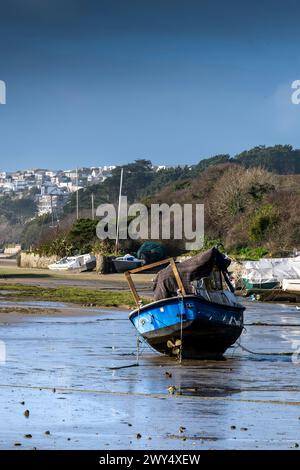 Sailing craft boats sail boats in various states of disrepair moored at low tide on the tidal Gannel Estuary in Newquay in Cornwall in the UK. Stock Photo