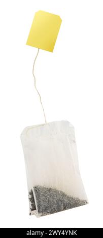 Rectangular shaped tea bag with string and yellow paper label. File contains clipping path. Stock Photo