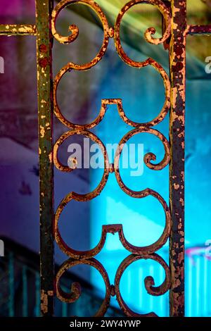 Intricate iron railing design on purple background Stock Photo
