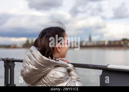 Girl on the embankment of the Rhine river in Bonn, Germany Stock Photo