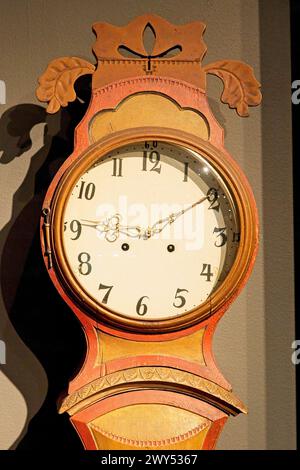 Detail closeup of old wooden grandfather clock face. Stock Photo