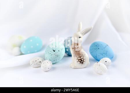 Easter composition with white rabbit and eggs on a white background. The minimal concept. Stock Photo