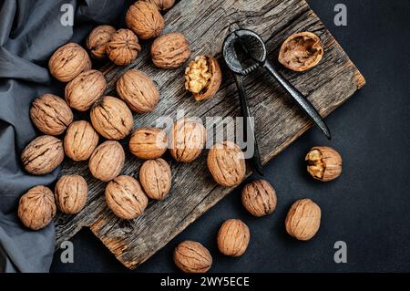 Ripe and raw whole big walnut kernel with shell on rustic backdrop. healthy nut food for brain Stock Photo