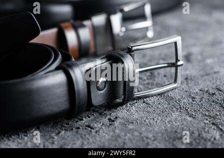 Fabric trousers faux leather black belt on rustic stone background, fashion style Stock Photo