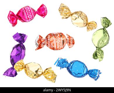 Candies in bright wrappers falling on white background Stock Photo