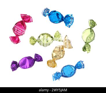 Candies in bright wrappers falling on white background Stock Photo