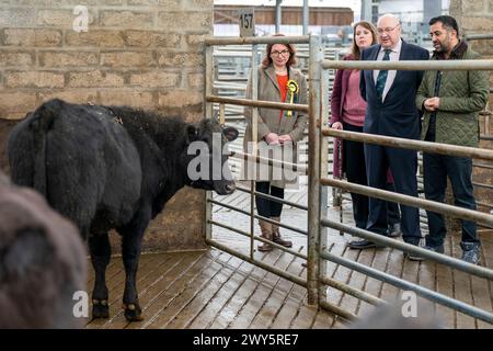 First Minister Humza Yousaf (right) with (from left) Lucy Beattie the SNP candidate for Caithness Sutherland and Easter Ross, Emma Roddick MSP and managing director Grant MacPherson during a visit to Dingwall and Highland Mart in Dingwall in The Highlands of Scotland. Picture date: Thursday April 4, 2024. Stock Photo