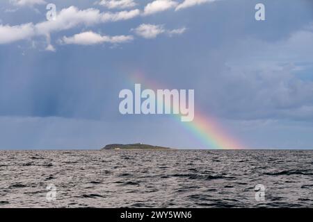 Rainbow and rain clouds, stormy skies over Hjelm Island, Kattegat, Denmark Stock Photo