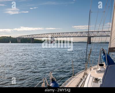 Sailboat sailing towards Old Little Belt Bridge connecting Jutland and Funen in Southern Denmark, Denmark Stock Photo