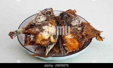 Fried fish served on a white plate Stock Photo