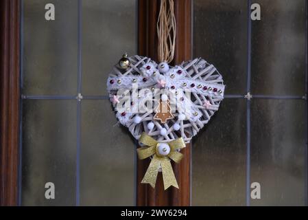 Festive heart shaped Christmas decorations on the exterior of an Alsatian rural half-timbered house in Bergheim, Alsace France. Stock Photo