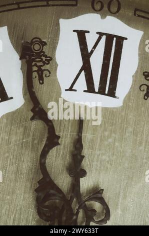 almost number 12 in roman numerals on vintage wall clock Stock Photo