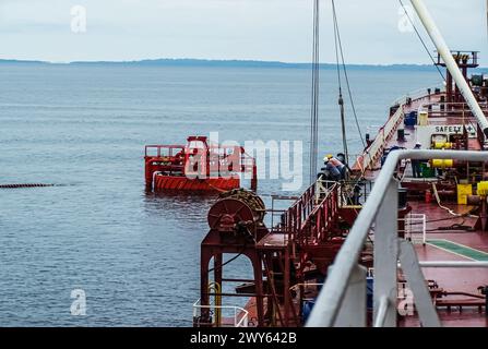 Offshore oil loading from single buoy mooring into oil tanker. Single buoy mooring serves as mooring point for tankers loading and offloading gas and Stock Photo