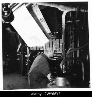 THE SOLDIER MAGAZINE IN HAMBURG - Once the cylinders have been etched they are then ready to be put onto the machines. German printer is making final adjustments to get them in correct register. About five thousand copies are run before correct adjustments attained. , British Army of the Rhine Stock Photo