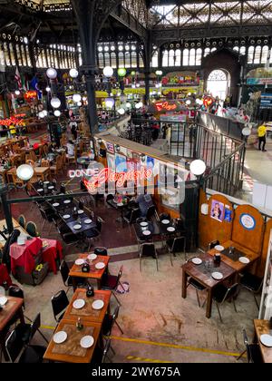 Inside view of the Santiago de Chile Central market, its statue the Chile Flag and the tourist and traditional restaurant Donde Augusto Stock Photo