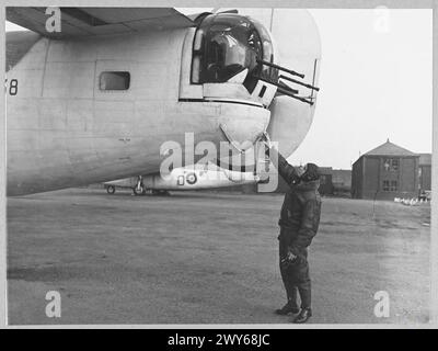 DEFEATING GERMANY'S KEY WEAPON : LIBERATOR v. U-BOAT - For story see CH.9576 (Picture issued 1943) The rear gunner inspecting the exterior of his turret before flight. , Royal Air Force Stock Photo