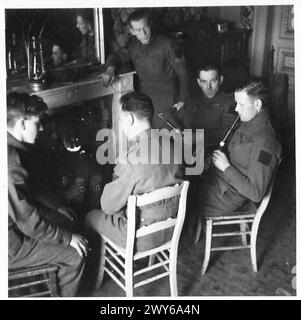 5TH SEAFORTH HIGHLANDERS PIPE BAND - Now to get those fingers thawed out after that practice in the snow. A good log fire, an open grate and you might almost be at home. , British Army, 21st Army Group Stock Photo