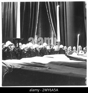 CEREMONIAL FUNERAL OF BRUSSELS POLICE SHOT BY THE GERMANS - Belgian policemen salute the coffins during the Service , British Army, 21st Army Group Stock Photo