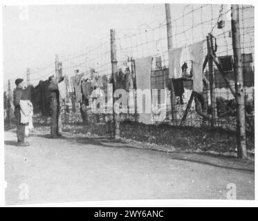 In November 1943, British prisoners of war rested beside a hut at ...