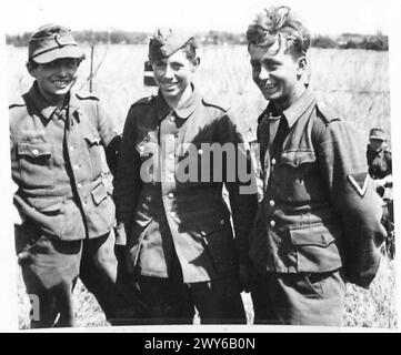 THE NORMANDY OFFENSIVE - VARIOUS - Three young German prisoners of 19 Panzer Grenadiers, one a Lance Corporal who seems to be very happy to be out of the war. They were captured during the fighting in the Caen sector. , British Army, 21st Army Group Stock Photo