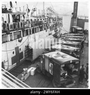 Ambulance lorries are stationed on a pierhead during British Army, 21st Army Group operations in North-West Europe, 1944-1946. Stock Photo