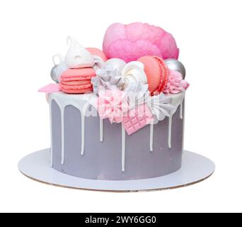Tall pink cake decorated with macaroons, raspberries and flowers isolated over white background. Side view, copy space, png Stock Photo
