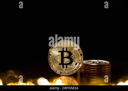 Bitcoin cryptocurrency with colorfull blurred bokeh on black background. Stock Photo