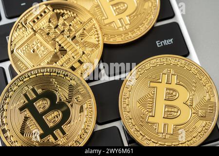 Cryptocurrency bitcoin gold coins on keyboard. Stock Photo