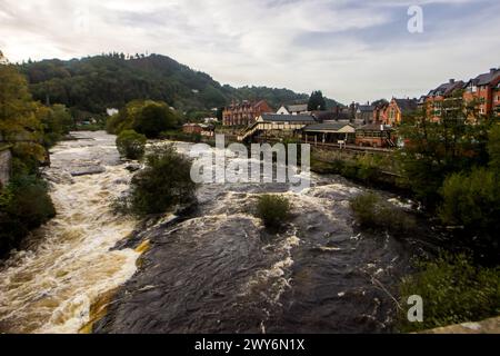 View over the rushing water of the River Dee from the Medieval bridge in the Town of Llangollen in Northwest Wales Stock Photo