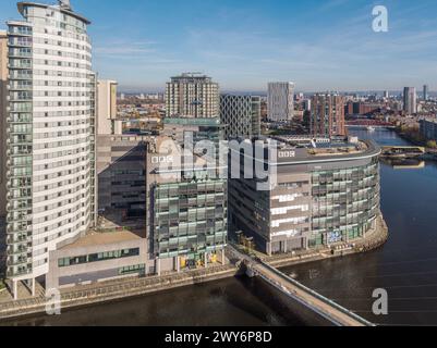 Aerial photograph over the Manchester Ship Canal of The Heart & BBC Studios at MediaCityUK looking down Huron & Eerie Basins in Salford Quays, UK Stock Photo