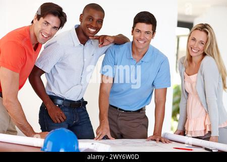 Architect, blueprint and portrait of team for design meeting, planning or project development on home renovation. Engineering, diversity and Stock Photo