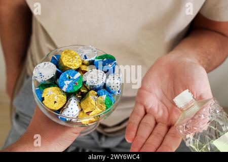 Young man pouring cologne to an elder man with a bowl of candy or chocolate. Eid al fitr in Turkey background video. Traditional Eid al Fitr candies. Stock Photo