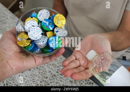 Young man pouring cologne to an elder man with a bowl of candy or chocolate. Eid al fitr in Turkey background video. Traditional Eid al Fitr candies. Stock Photo