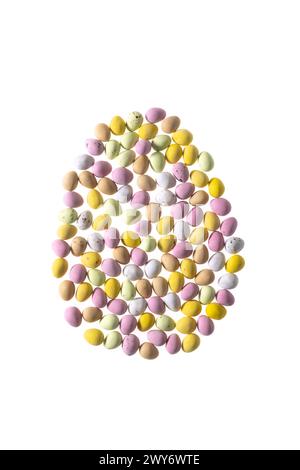 Colourful sugar coated mini eggs arranged in an egg shape on a white background Stock Photo