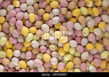 Flat lay of pastel coloured sugar-coated chocolate mini eggs Stock Photo