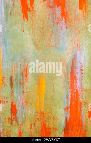 Abstract art painting in orange and green hues with paintbrushes Stock Photo