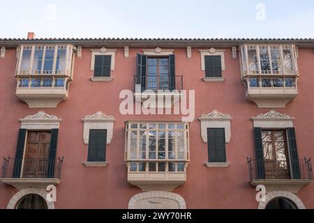Beautiful Spanish-style windows and balconies, the facade of an old residential house in Palma, Mallorca, Spain Stock Photo